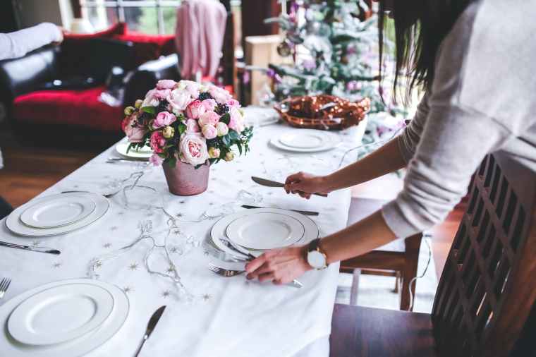 woman preparing christmas table